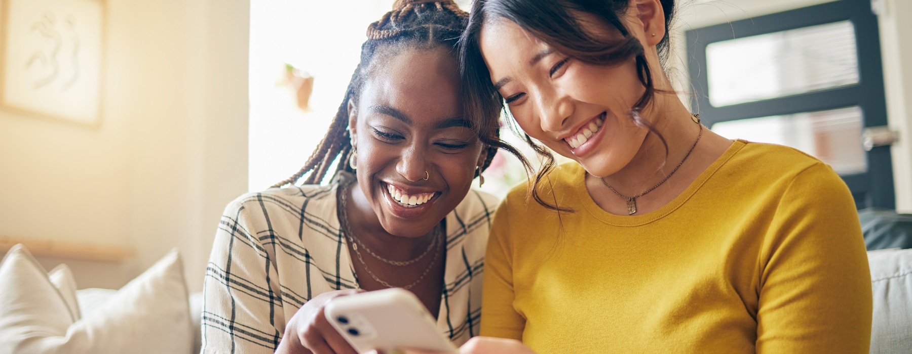 friends hanging out looking t at phone