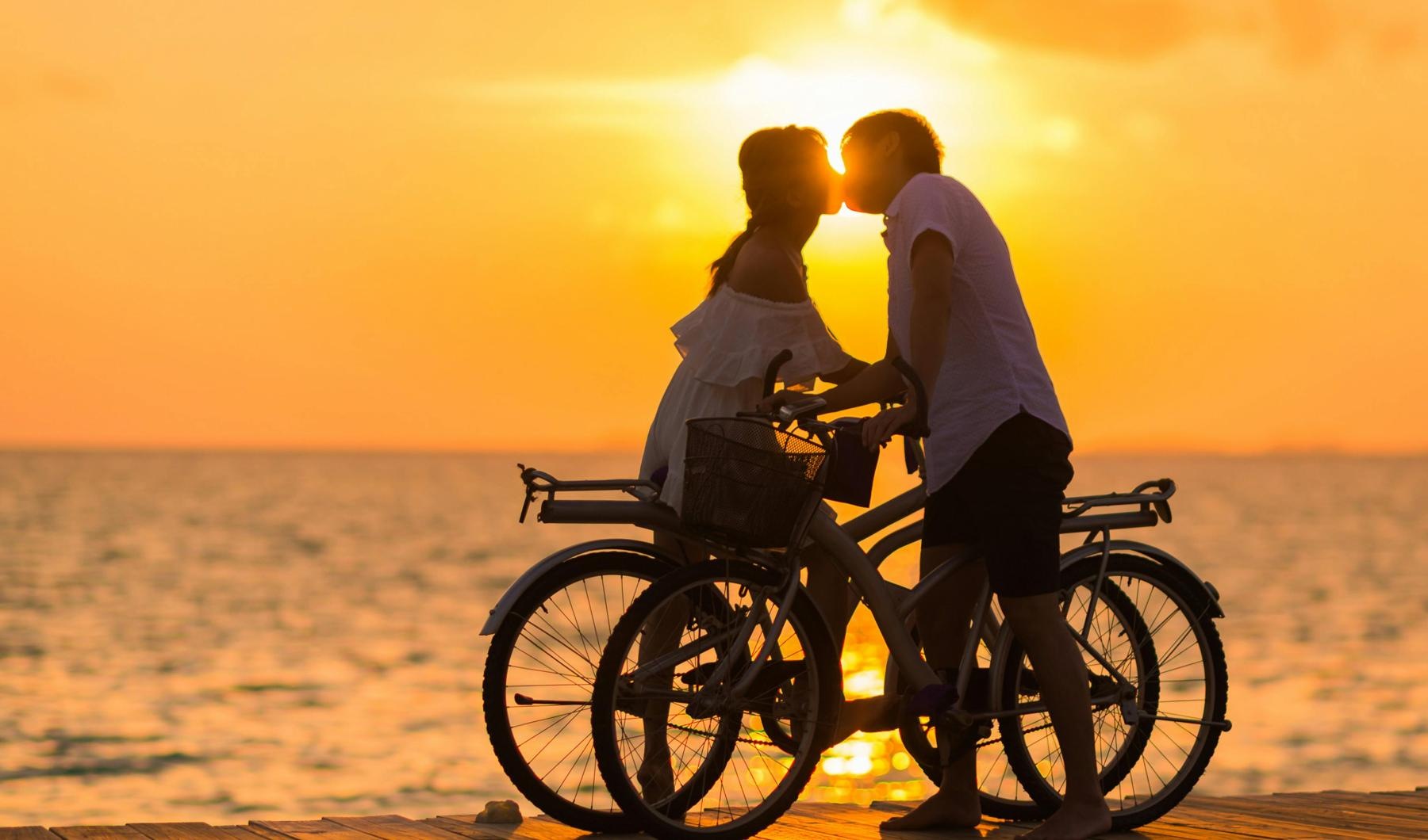 a man and woman on a bicycle