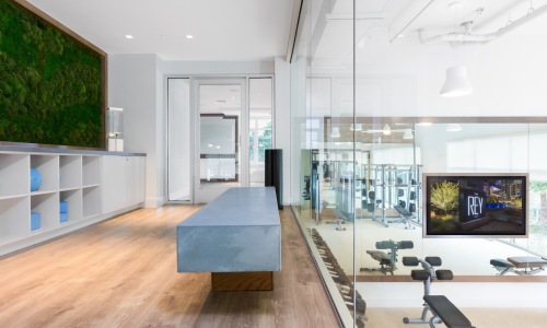 a room with a large bench and wooden-style flooring