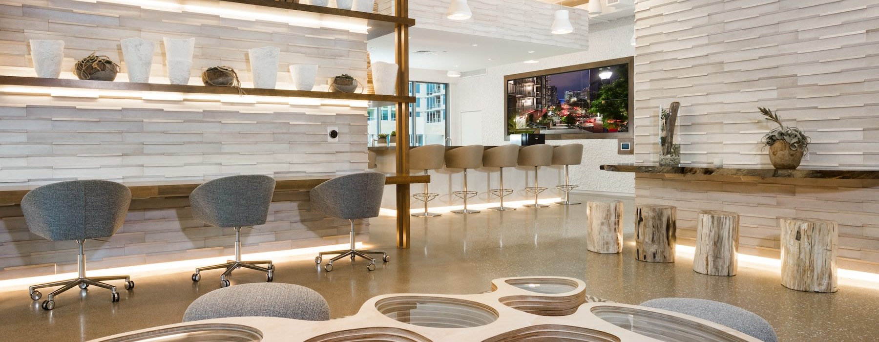 a room with a desk, tables, and chairs