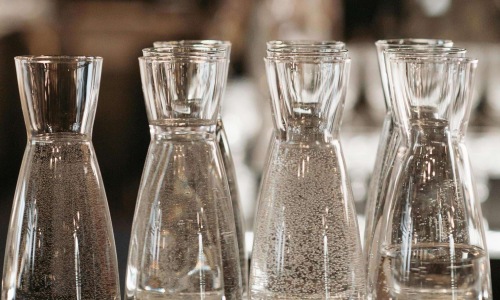 a group of beakers with liquid in them