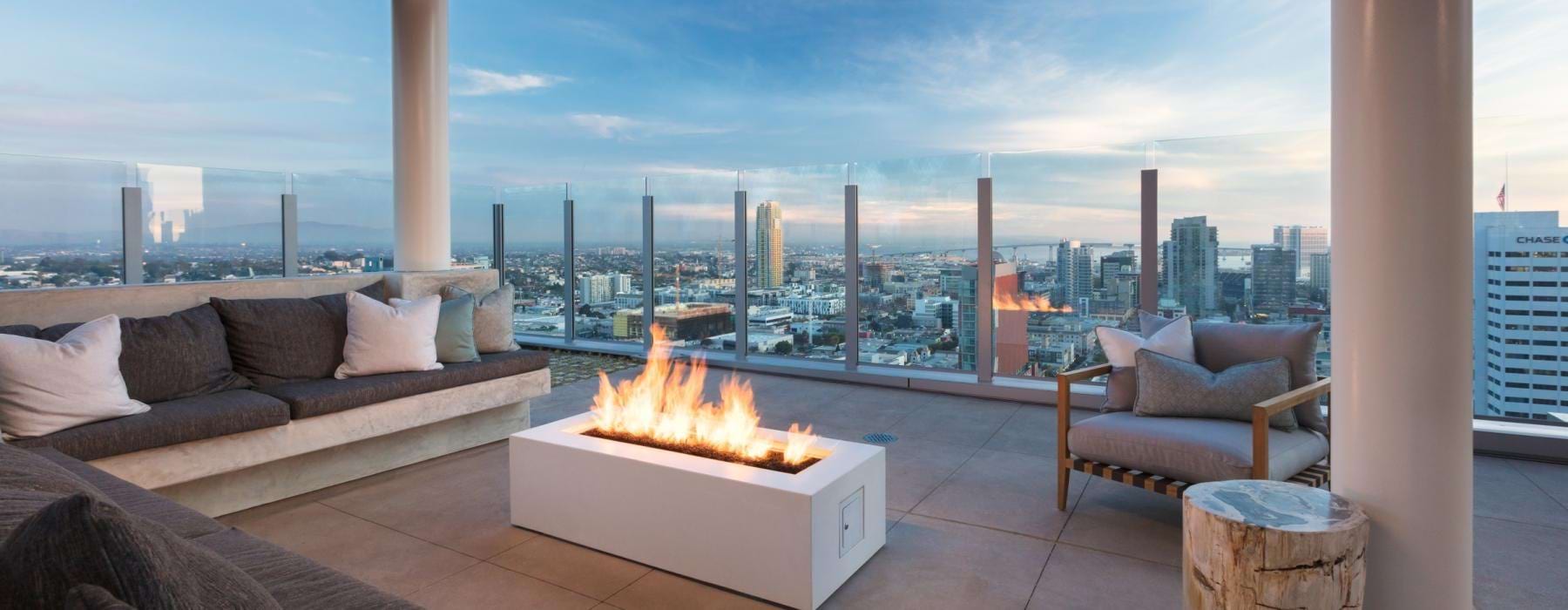 a room with a fire and a view of a city