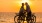 a man and woman on a bicycle