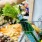 a person holding a shopping cart full of vegetables