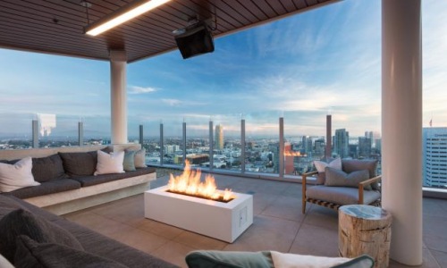 a room with a fire and a view of a city